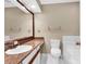 Bathroom with a granite countertop, large mirror, toilet, and a tiled bathtub at 6200 Summertree Ln, Charlotte, NC 28226