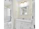 A white bathroom featuring a shower with glass doors, a toilet, and a vanity with a large framed mirror at 6200 Summertree Ln, Charlotte, NC 28226