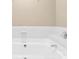 A white bathtub with tile surround and chrome fixtures at 6200 Summertree Ln, Charlotte, NC 28226