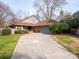 Charming home featuring a long concrete driveway and a well-maintained lawn at 6200 Summertree Ln, Charlotte, NC 28226
