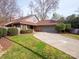 Well-maintained home exterior with a long driveway and mature landscaping at 6200 Summertree Ln, Charlotte, NC 28226