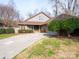 Charming home featuring a long concrete driveway and a well-maintained lawn at 6200 Summertree Ln, Charlotte, NC 28226
