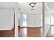 Bright, airy foyer with hardwood floors, high ceilings, and a decorative light fixture at 6200 Summertree Ln, Charlotte, NC 28226