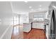 Modern kitchen featuring white cabinets, hardwood floors, and stainless steel appliances at 6200 Summertree Ln, Charlotte, NC 28226