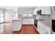 Modern kitchen featuring white cabinets, hardwood floors, and stainless steel appliances at 6200 Summertree Ln, Charlotte, NC 28226