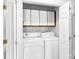Laundry room featuring a washer and dryer, cabinets, and bi-fold doors for easy access at 6200 Summertree Ln, Charlotte, NC 28226