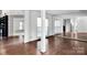 Living room featuring hardwood floors, mirrored wall, and white trim at 6200 Summertree Ln, Charlotte, NC 28226