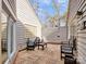 Private courtyard patio featuring unique wooden tiles and comfortable seating for outdoor enjoyment at 6200 Summertree Ln, Charlotte, NC 28226