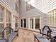 Charming courtyard patio with wooden tiles and seating, perfect for outdoor relaxation and entertaining at 6200 Summertree Ln, Charlotte, NC 28226