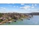 Expansive lakefront view featuring various docks and boat lifts along the peaceful shoreline, embodying lakeside living at 6403 Amos Smith Rd, Charlotte, NC 28214