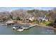 Aerial view of an estate with private docks and boat lifts, set against the serene backdrop of a sprawling lake at 6403 Amos Smith Rd, Charlotte, NC 28214