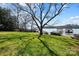 Expansive backyard with mature trees, offering picturesque views of the serene lake and boat docks at 6403 Amos Smith Rd, Charlotte, NC 28214