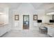 Bright bathroom with marble floors, vanity, towel racks, and open doorway at 6403 Amos Smith Rd, Charlotte, NC 28214