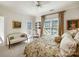 Comfortable bedroom featuring floral bedding, sofa, and access to a balcony at 6403 Amos Smith Rd, Charlotte, NC 28214