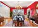 Formal dining room with red walls, hardwood floors, a large window, and chandelier at 6403 Amos Smith Rd, Charlotte, NC 28214