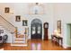 Grand foyer showcasing a staircase, hardwood floors, a decorative front door, and high ceilings at 6403 Amos Smith Rd, Charlotte, NC 28214