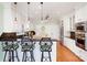 Bright kitchen features white cabinets, granite countertops, stainless appliances, and counter seating at 6403 Amos Smith Rd, Charlotte, NC 28214