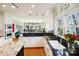 Open kitchen boasts granite counters, white cabinets, stainless steel appliances, and backyard views at 6403 Amos Smith Rd, Charlotte, NC 28214