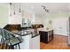 Spacious kitchen with white cabinets, black granite, an island, and stainless steel appliances at 6403 Amos Smith Rd, Charlotte, NC 28214