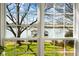 Lake view framed by a large grid window showcasing a gazebo with dock on lush lawn at 6403 Amos Smith Rd, Charlotte, NC 28214