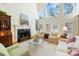 Cozy living room featuring a fireplace, built-in bookshelves, and large windows for ample natural light at 6403 Amos Smith Rd, Charlotte, NC 28214