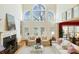 Bright and airy living room with large windows, a cozy fireplace, and comfortable seating arrangements at 6403 Amos Smith Rd, Charlotte, NC 28214