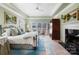 Comfortable main bedroom with a fireplace, soft green walls, and a ceiling fan at 6403 Amos Smith Rd, Charlotte, NC 28214