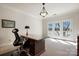 Bright office space featuring a large desk, and light-filled double doors to balcony at 6403 Amos Smith Rd, Charlotte, NC 28214