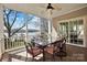 Inviting screened porch with ceiling fan and outdoor seating, overlooking scenic lake views at 6403 Amos Smith Rd, Charlotte, NC 28214