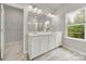 Bright bathroom featuring double sink vanity, large mirror, updated fixtures, and natural light at 769 River Park Rd, Belmont, NC 28012