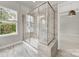 Modern bathroom featuring a glass shower with marble tile and natural light at 769 River Park Rd, Belmont, NC 28012