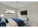 Virtually staged bedroom with neutral walls, carpet, natural light, and modern light fixture at 769 River Park Rd, Belmont, NC 28012