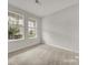 Bright, carpeted bedroom with natural light streaming through two large windows, showcasing a cozy space at 769 River Park Rd, Belmont, NC 28012