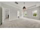Spacious bedroom with neutral walls, carpet, natural light, and tray ceilings at 769 River Park Rd, Belmont, NC 28012