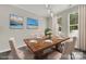 Staged dining room featuring natural light, wood table, and coastal artwork at 769 River Park Rd, Belmont, NC 28012