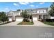 Attractive townhome with a one-car garage and manicured landscaping on a sunny day at 769 River Park Rd, Belmont, NC 28012