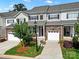 A townhome with a stone facade, attached garage, and professionally landscaped front yard at 769 River Park Rd, Belmont, NC 28012