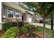 A well-maintained townhome with a stone facade, covered porch, and manicured landscaping at 769 River Park Rd, Belmont, NC 28012