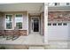 Charming front porch with rocking chairs, stone accents, and a well-lit entrance, offering curb appeal at 769 River Park Rd, Belmont, NC 28012