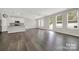 Open concept living area, with island kitchen, and gray tone vinyl floors at 769 River Park Rd, Belmont, NC 28012