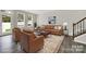 Living room area featuring natural light, leather seating arrangement, and area rug at 769 River Park Rd, Belmont, NC 28012