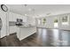 Open-concept living space with sleek flooring, modern lighting, and access to a kitchen, perfect for entertaining at 769 River Park Rd, Belmont, NC 28012