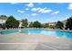 Community swimming pool surrounded by lounge chairs, greenery, and blue skies at 769 River Park Rd, Belmont, NC 28012
