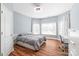 Comfortable bedroom with wood floors, ample natural light, and a ceiling fan at 8504 Soaring Eagle Ln, Waxhaw, NC 28173