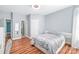 Cozy bedroom featuring wood floors, a neutral color scheme, and plenty of natural light at 8504 Soaring Eagle Ln, Waxhaw, NC 28173