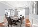Elegant dining room featuring tray ceiling, wainscoting, and a large table set for eight at 8504 Soaring Eagle Ln, Waxhaw, NC 28173