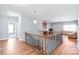 Upstairs hallway that showcases hardwood floors and a wrought iron railing at 8504 Soaring Eagle Ln, Waxhaw, NC 28173