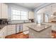 Kitchen with granite counters, stainless appliances, island with sink, and views to other living spaces at 8504 Soaring Eagle Ln, Waxhaw, NC 28173