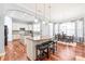 Open-concept kitchen with granite countertops, stainless steel appliances, and breakfast bar seating at 8504 Soaring Eagle Ln, Waxhaw, NC 28173