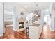 Open-concept living room with fireplace, kitchen island, and view of the elegant staircase at 8504 Soaring Eagle Ln, Waxhaw, NC 28173